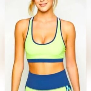 Fourlaps NWT Infinity Sports Bra Tomatillo Midnight White with crossed straps.
